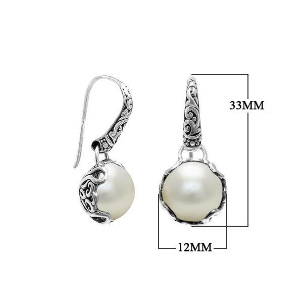 Wholesale sterling silver earrings featuring luminous Mabe pearls set in ornate Balinese-style silver detailing, crafted to deliver consistent artisan quality and an elegant catalog-ready presentation for wholesale jewelry buyers.