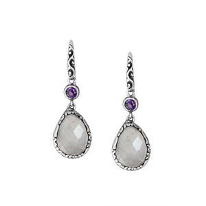 Wholesale sterling silver earrings combining a faceted rainbow moonstone teardrop with an amethyst quartz accent, framed by ornate Balinese detailing for consistent artisan quality and strong catalog-ready wholesale presentation.