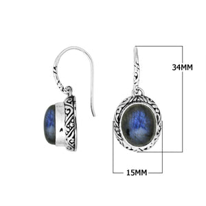 Wholesale sterling silver earrings featuring an oval Labradorite cabochon framed with detailed carved silver and earwire lock, offering artisan craftsmanship and captivating labradorescent color for premium wholesale jewelry catalogs.