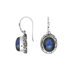 Wholesale sterling silver earrings featuring an oval Labradorite cabochon framed with detailed carved silver and earwire lock, offering artisan craftsmanship and captivating labradorescent color for premium wholesale jewelry catalogs.