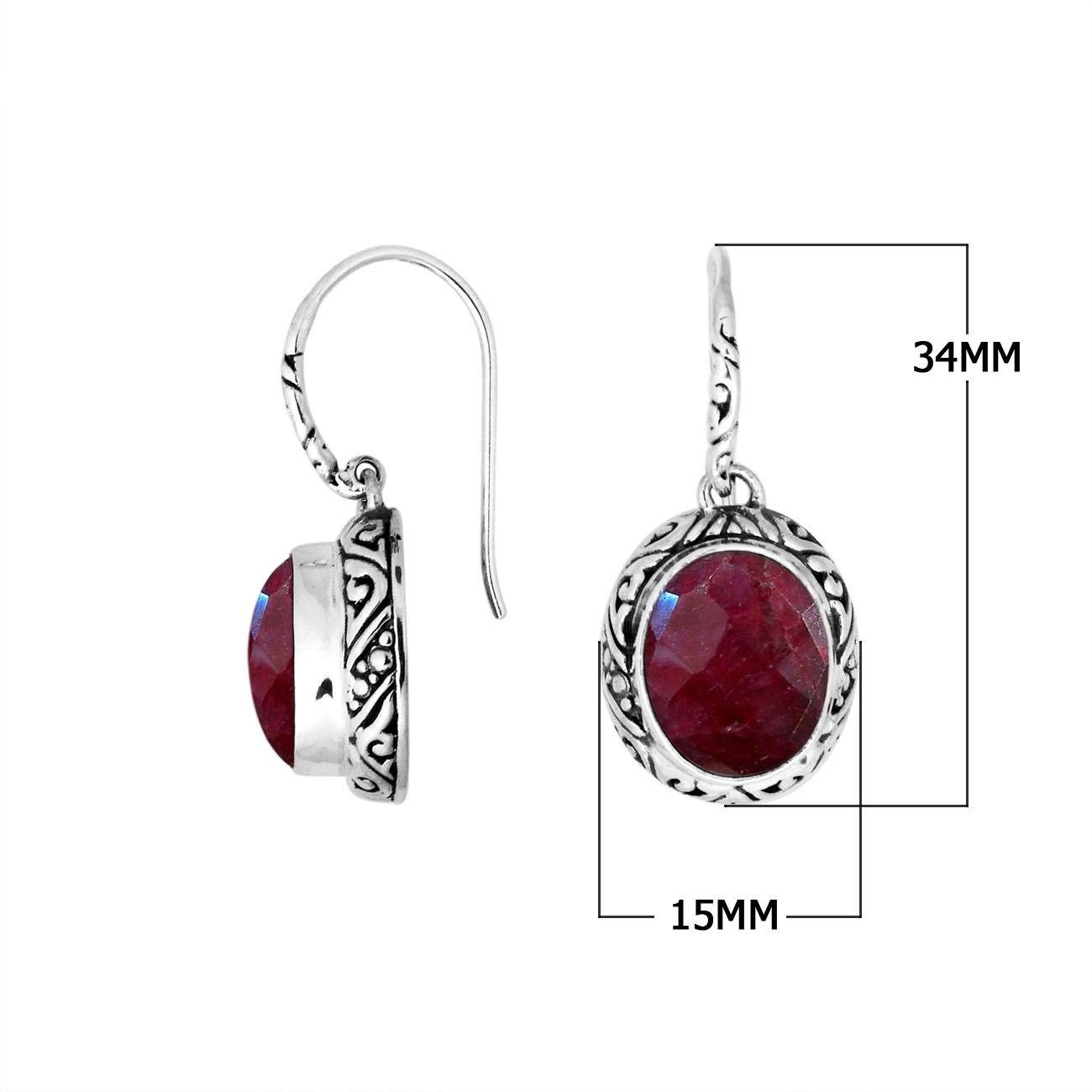 Wholesale sterling silver earrings featuring an oval faceted Ruby Quartz stone set within ornate carved silver detailing and an earwire lock, offering vibrant color and artisan style ideal for premium wholesale catalogs.