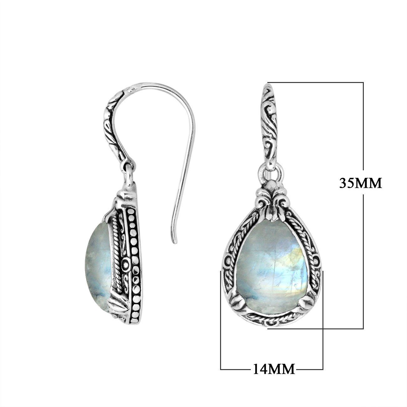 Wholesale sterling silver earrings featuring a softly glowing Rainbow Moonstone teardrop framed with sculpted ornate borders and secured with an earwire lock, ideal for serene, luminous, artisan-inspired wholesale presentations.