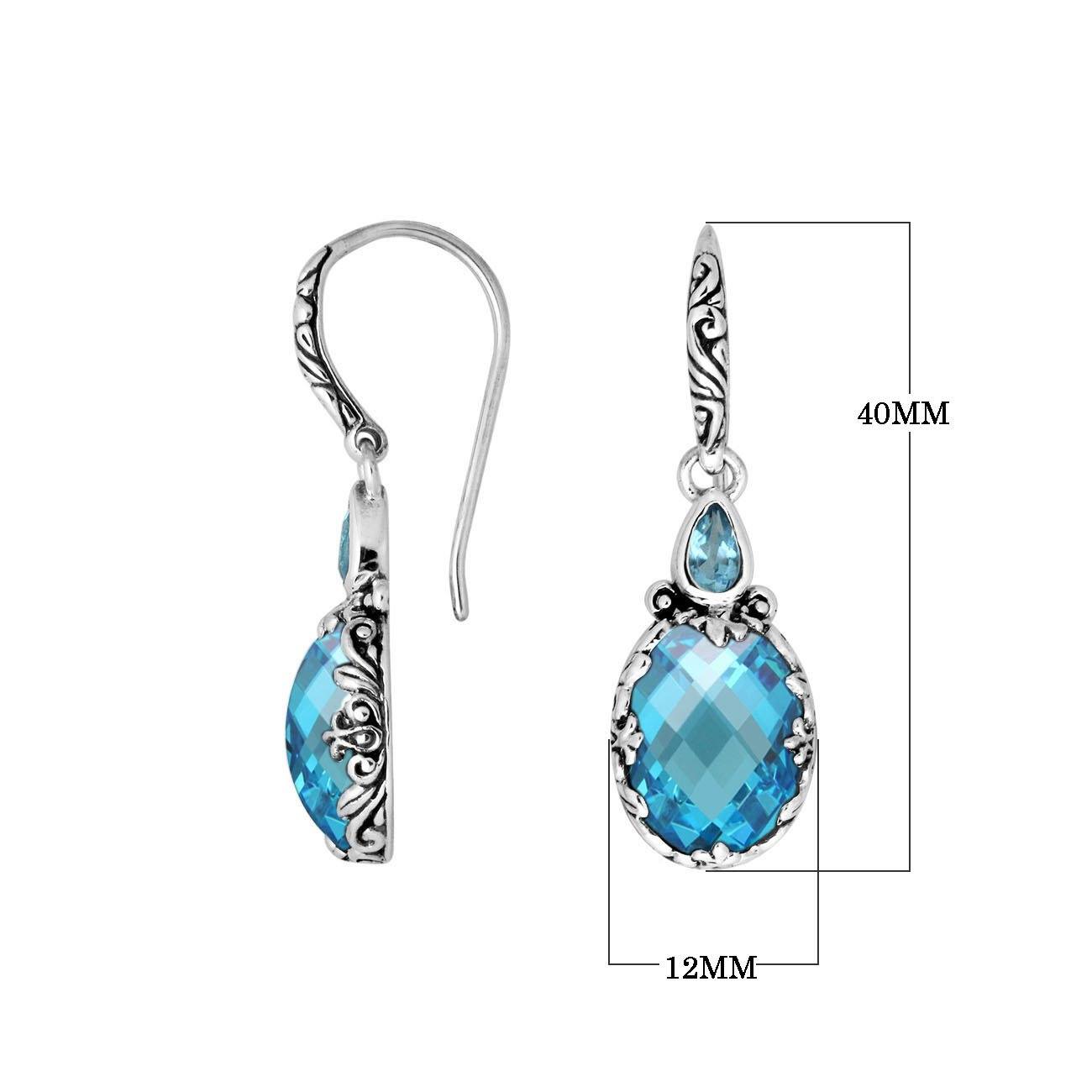 Wholesale sterling silver earrings featuring a brilliant faceted Blue Topaz Quartz teardrop framed with ornate carved details and secure earwire lock for refined, bright wholesale jewelry collections.