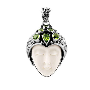 Wholesale sterling silver pendant with hand-carved bone face and peridot gemstones, Bali artisan jewelry in bulk.