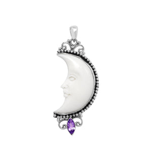 Sterling silver half-moon pendant with carved bone face and amethyst gemstone, Balinese design.