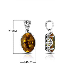 Sterling silver pendant with oval-cut citrine quartz, handcrafted in Bali with scroll carvings and oxidized finish.