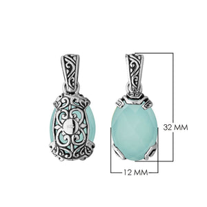 A handcrafted sterling silver pendant featuring a serene Green Chalcedony Quartz set in an ornate Balinese filigree frame with detailed silver artistry.