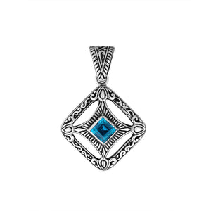A handcrafted sterling silver pendant featuring a radiant Blue Topaz Quartz in a detailed Balinese filigree square frame with artistic silverwork.