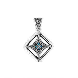A handcrafted sterling silver pendant featuring a radiant Blue Topaz Quartz in a detailed Balinese filigree square frame with artistic silverwork.
