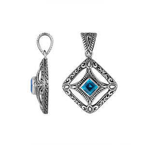 A handcrafted sterling silver pendant featuring a radiant Blue Topaz Quartz in a detailed Balinese filigree square frame with artistic silverwork.