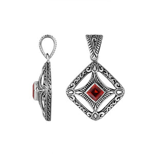 A handcrafted sterling silver pendant featuring a radiant Red Garnet Quartz in a Balinese filigree square frame with detailed silverwork.
