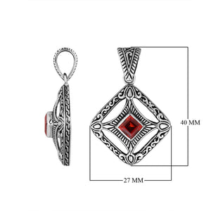 A handcrafted sterling silver pendant featuring a radiant Red Garnet Quartz in a Balinese filigree square frame with detailed silverwork.