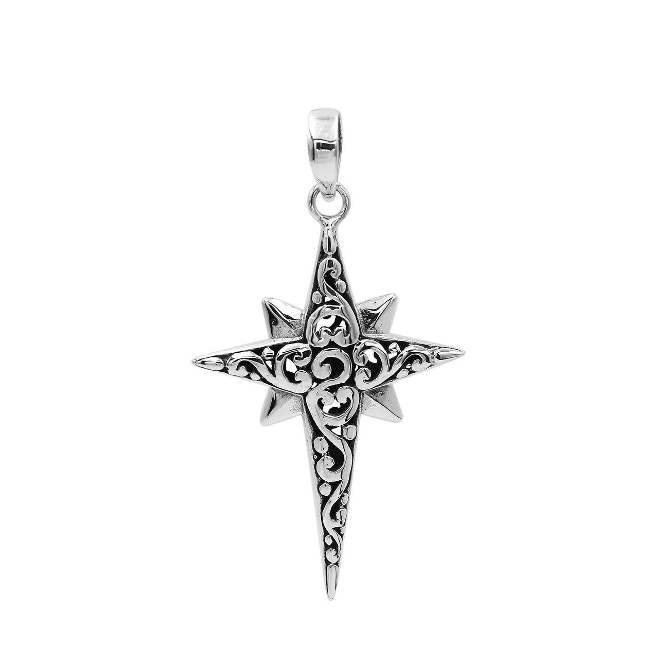 A handcrafted sterling silver compass star pendant featuring ornate Balinese filigree detailing and a high-polished finish.