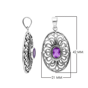 A handcrafted sterling silver pendant featuring a radiant Amethyst Quartz centered in a detailed Balinese filigree oval frame.