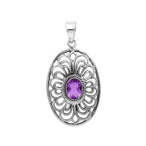 A handcrafted sterling silver pendant featuring a radiant Amethyst Quartz centered in a detailed Balinese filigree oval frame.