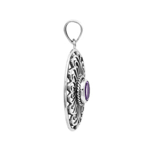 A handcrafted sterling silver pendant featuring a radiant Amethyst Quartz centered in a detailed Balinese filigree oval frame.