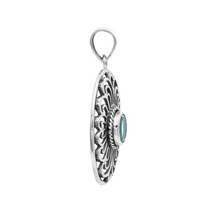 A handcrafted sterling silver pendant featuring a radiant Blue Topaz Quartz gemstone centered in an elegant Balinese filigree oval frame.