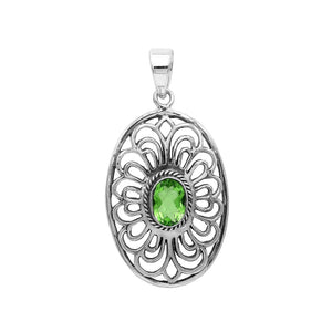 Handcrafted sterling silver pendant with Peridot Quartz in an oval Balinese filigree frame and polished silver finish.