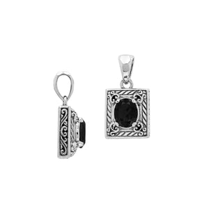 Rectangular sterling silver pendant featuring oval black onyx quartz centerpiece with swirl engravings and polished Balinese silver detailing.