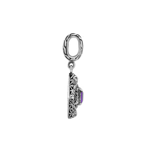 Diamond-shaped sterling silver pendant featuring square amethyst quartz centerpiece, filigree engraving, and smooth polished finish in classic Balinese design.