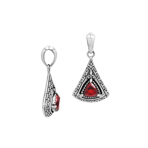 Triangular sterling silver pendant featuring red garnet quartz trillion-cut centerpiece, geometric Balinese engravings, and smooth high-gloss polish.
