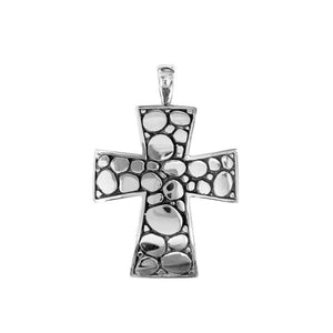 Sterling silver cross pendant featuring polished pebble texture and oxidized Balinese handcrafted detailing.