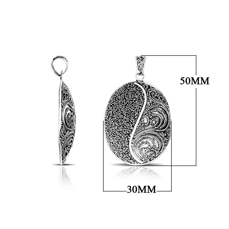 Sterling silver oval pendant featuring Yin-Yang filigree texture with oxidized handcrafted Balinese finish.