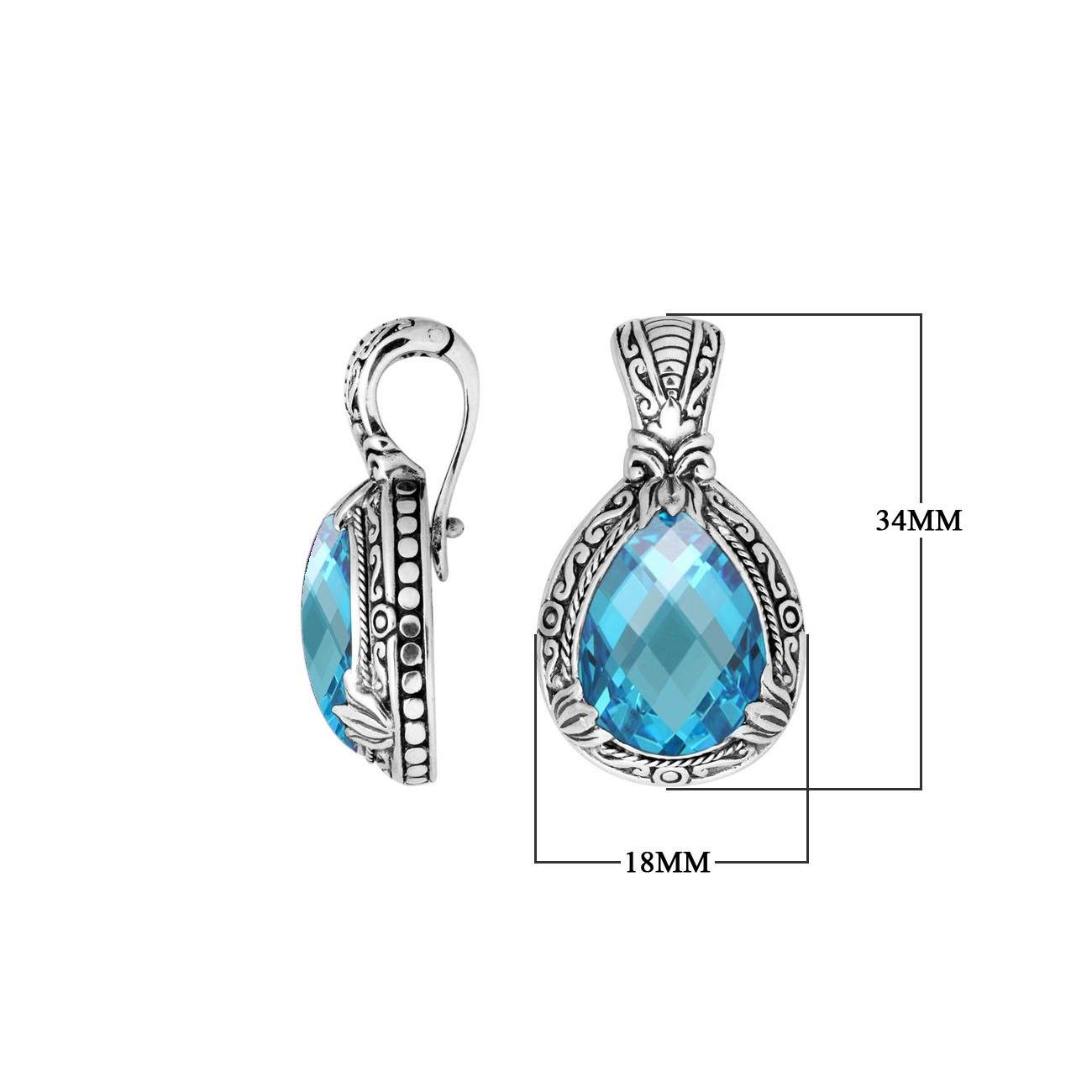 Sterling silver pendant showcasing a faceted Blue Topaz Quartz teardrop set in a carved Balinese frame with a glossy polished finish.