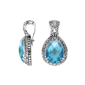 Sterling silver pendant showcasing a faceted Blue Topaz Quartz teardrop set in a carved Balinese frame with a glossy polished finish.