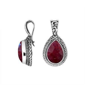 Sterling silver teardrop pendant featuring faceted Ruby Quartz set in a carved Balinese frame with a polished glossy finish.