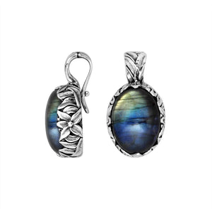 Sterling silver oval pendant featuring Labradorite framed with detailed Balinese floral engraving.