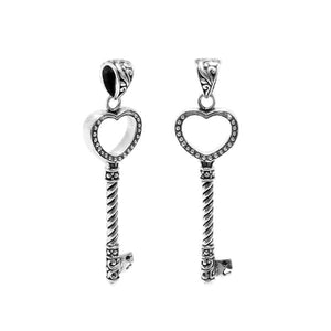 Sterling silver heart-shaped key pendant featuring dotted texturing, twisted stem detailing, and polished finishing suitable for classic wholesale jewelry displays