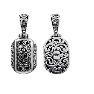 A wholesale Silver Overlay Over Copper oval pendant featuring ornate Balinese scrollwork, oxidized detailing, polished highlights, and a refined silver overlay design ideal for bulk jewelry buyers.