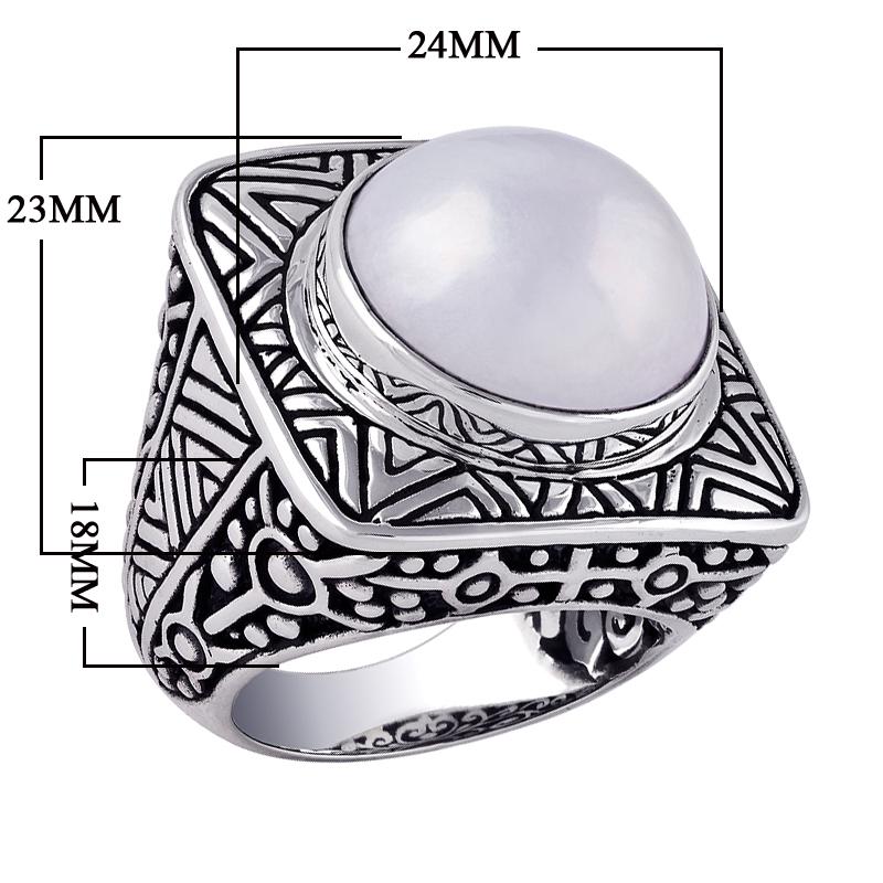 Wholesale sterling silver ring with bold square shank, featuring a large round white Mabe Pearl cabochon, accented with intricate oxidized Bali-style carvings, handcrafted artisan men’s statement jewelry.