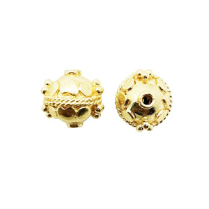 Round dome-shaped bead with 18K gold overlay over copper featuring raised decorative patterns handcrafted in India