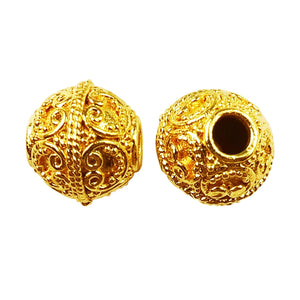 Handcrafted 18K gold overlay over copper filigree round bead from India with ornate scroll design.