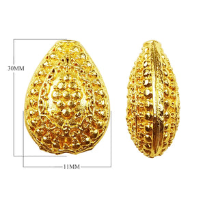 Handcrafted textured oval bead with 18K gold overlay over copper, featuring embossed dot patterns, made in India for wholesale jewelry production.