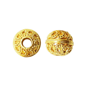 Handcrafted embossed round bead with 18K gold overlay over copper, featuring swirling motifs, made in India for wholesale jewelry making.