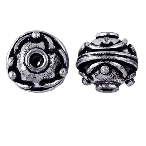 Antique silver overlay over copper round spacer bead with raised dot design handcrafted in India for wholesale jewelry use.