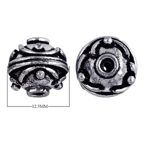 Antique silver overlay over copper round spacer bead with raised dot design handcrafted in India for wholesale jewelry use.