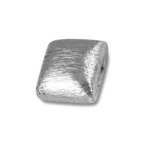 Handcrafted silver textured geometric bead with silver overlay over copper, made in India for wholesale jewelry making.