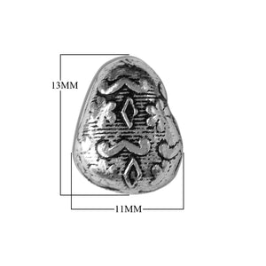 Handcrafted tribal bead cap with silver overlay over copper, featuring raised diamond motifs and oxidized finish, made in India.