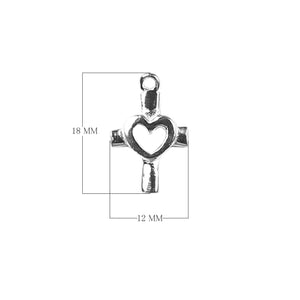 Handcrafted silver overlay cross charm with cutout heart made of silver overlay over copper in India.