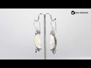 Sterling silver lunar bone face earrings with blue topaz quartz accent and earwire lock