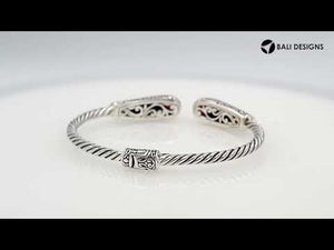 Sterling silver twisted bangle with garnet quartz ends and Balinese oxidized dot pattern