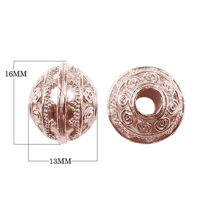 Round spacer bead with spiral scroll motifs in rose gold overlay over copper, handcrafted in India