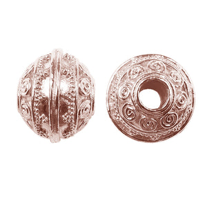 Round spacer bead with spiral scroll motifs in rose gold overlay over copper, handcrafted in India
