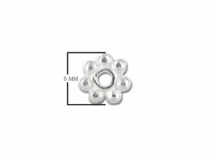 Daisy-shaped spacer bead crafted in silver overlay over copper with oxidized granulated detailing.