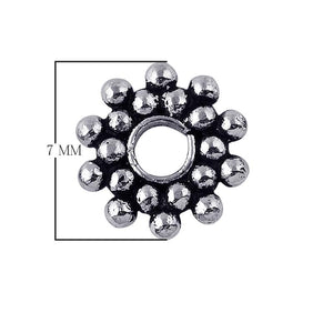 Sunburst-style granulated spacer bead in silver overlay over copper with oxidized detailing and open center.