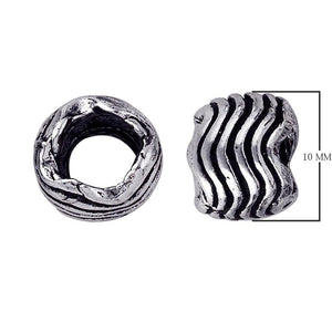 Organic wavy barrel spacer bead with carved grooves in silver overlay over copper.